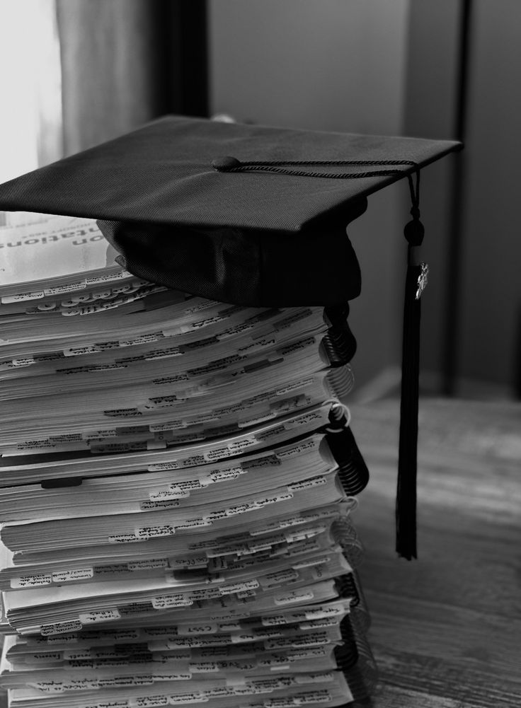 Graduation cap on stack of document folders