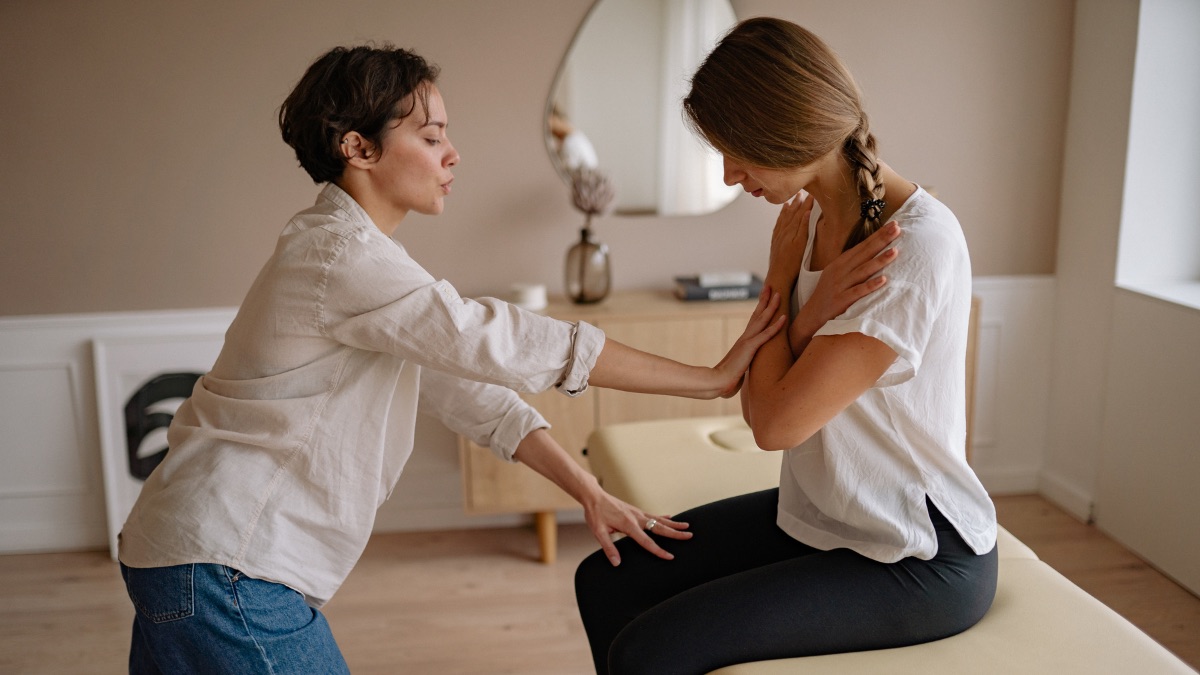 A clinician carrying out a physical assessment of a patient during a medico-legal examination